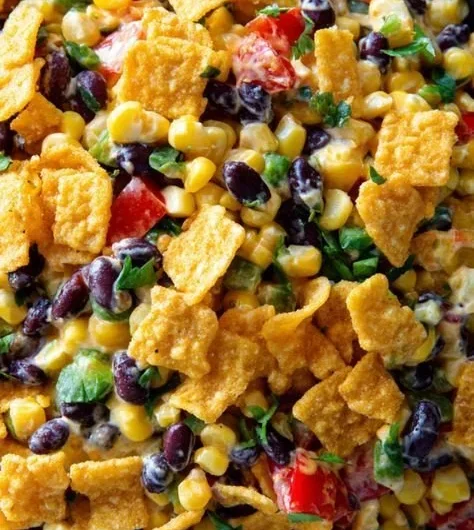Delicious creamy Frito corn salad in a bowl, perfect for summer picnics.