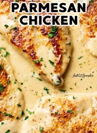 Creamy garlic parmesan chicken served on a plate with garnishes.