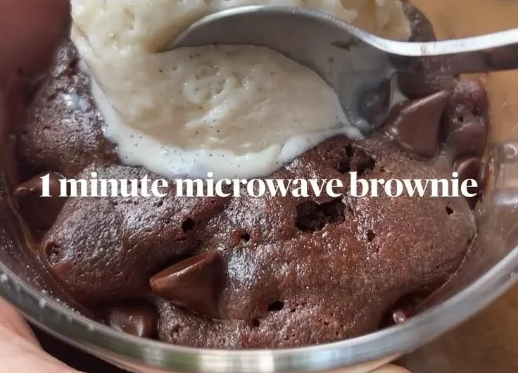 Fudgy brownie mug cake in a white mug topped with chocolate chips