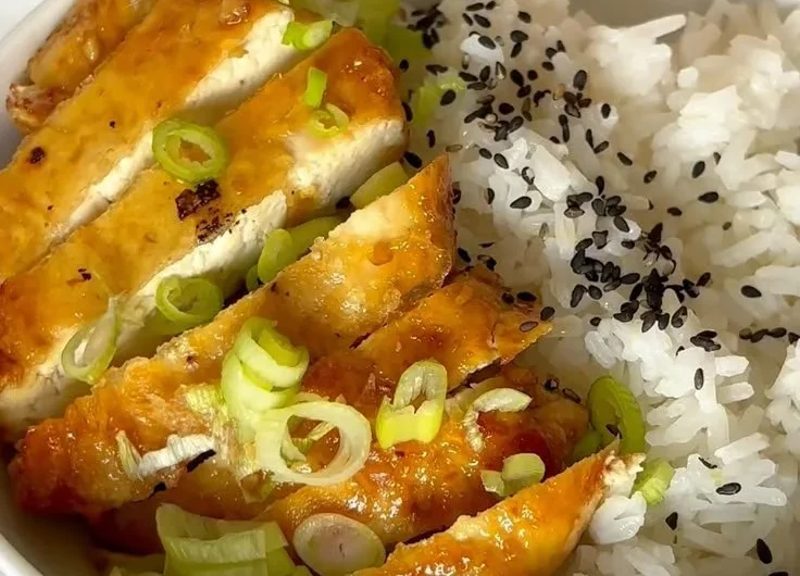 Delicious dish of honey garlic tofu served with vegetables and rice