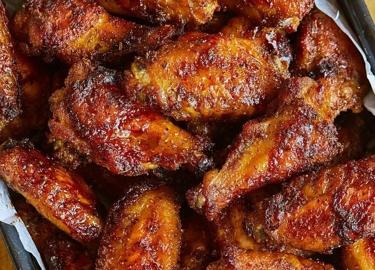 Delicious juicy chicken wings coated in savory sauce ready to be served.