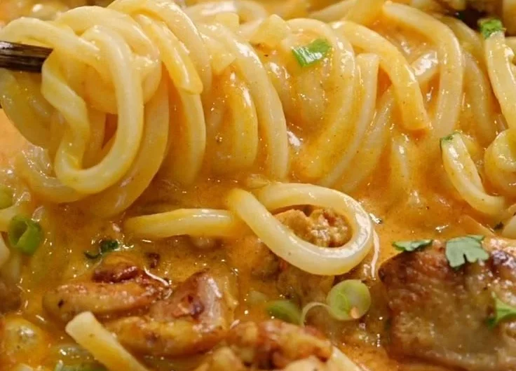Delicious Thai-inspired coconut red curry chicken served over udon noodles