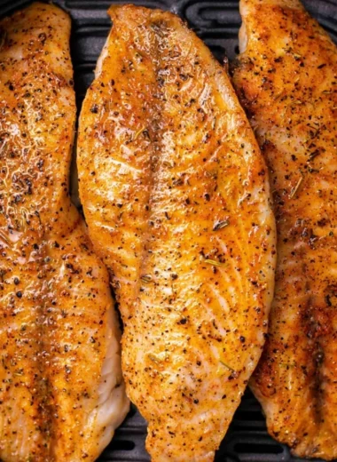Delicious Air Fryer Tilapia garnished with herbs and lemon slices