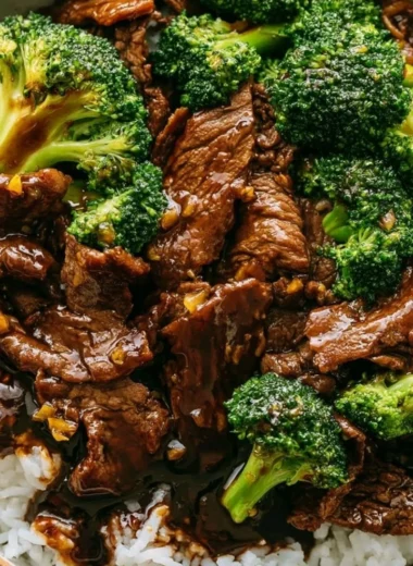 Delicious Beef and Broccoli stir-fry served on a plate with rice.