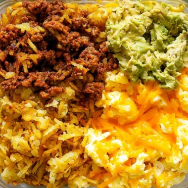 Healthy breakfast burrito bowl filled with eggs, vegetables, and salsa