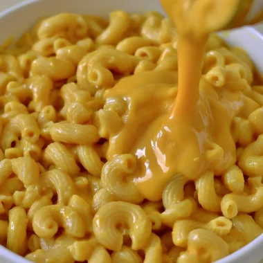 Creamy vegan mac and cheese dish without cashews, topped with herbs.