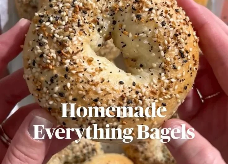 Freshly baked homemade everything bagels topped with seeds and seasonings.