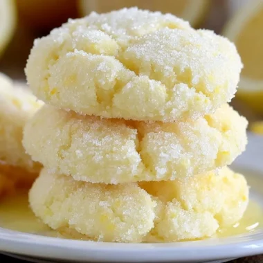 Baked lemon cake mix cookies with a lemon glaze on a white plate