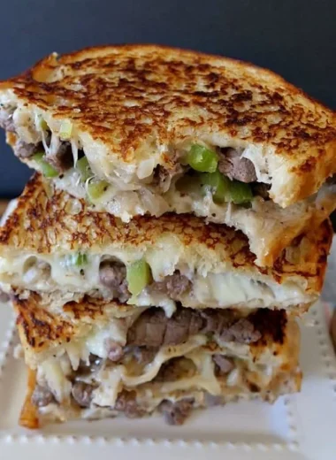 Mouthwatering Philly Cheesesteak Grilled Cheese sandwich loaded with gooey cheese.