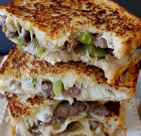 Mouthwatering Philly Cheesesteak Grilled Cheese sandwich loaded with gooey cheese.