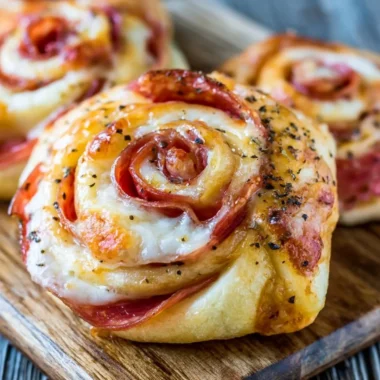 A plate of golden, crispy pizza rolls filled with cheese and pepperoni.