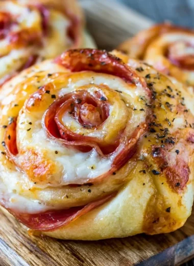 A plate of golden, crispy pizza rolls filled with cheese and pepperoni.
