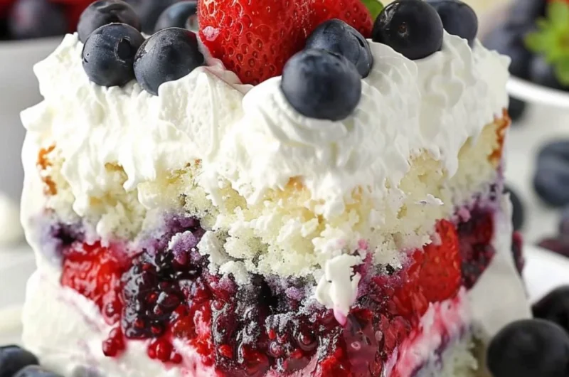 Delicious Summer Berry Poke Cake topped with fresh berries and whipped cream