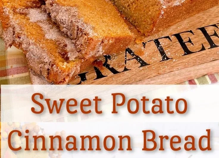 A loaf of freshly baked Sweet Potato Bread sliced and served with butter.