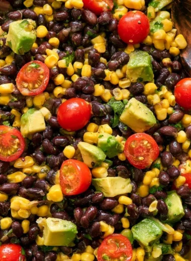 Vegan black bean salad in a bowl with colorful vegetables and herbs