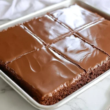 Cozy chocolate sheet cake baked for two, garnished with chocolate frosting.