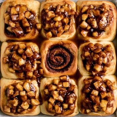 Apple pie cinnamon rolls drizzled with icing and cinnamon sugar