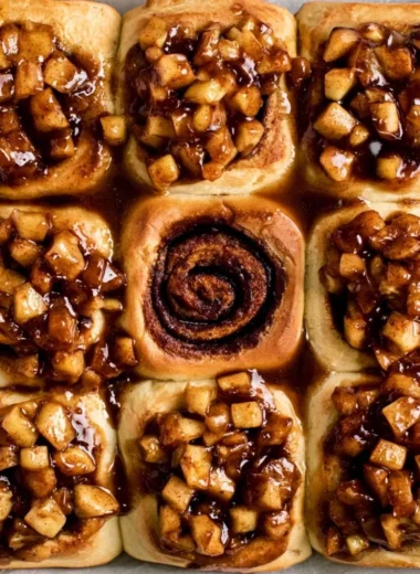 Apple pie cinnamon rolls drizzled with icing and cinnamon sugar