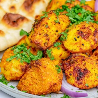 Plate of authentic Bombay Potatoes seasoned with spices and herbs