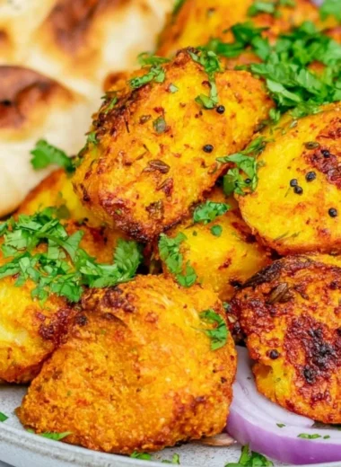 Plate of authentic Bombay Potatoes seasoned with spices and herbs