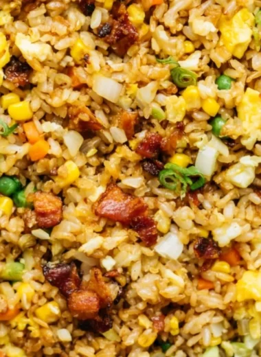 A delicious plate of Breakfast Fried Rice garnished with vegetables and eggs