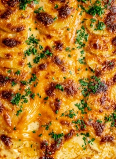 Deliciously creamy and cheesy cozy au gratin potatoes dish cooked to perfection.