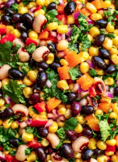 Bowl of Cozy Cowboy Caviar with fresh vegetables and black beans
