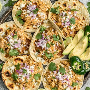Delicious crockpot chicken tacos served on a wooden table