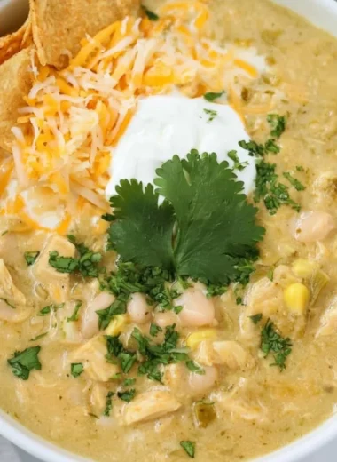 Delicious bowls of cozy green chile chicken enchilada soup topped with fresh ingredients.