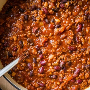 Bowl of cozy ground turkey chili topped with fresh herbs