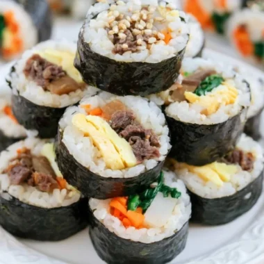 A beautiful plate of Kimbap, showcasing colorful ingredients wrapped in seaweed.
