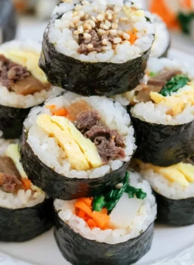 A beautiful plate of Kimbap, showcasing colorful ingredients wrapped in seaweed.
