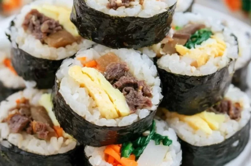A beautiful plate of Kimbap, showcasing colorful ingredients wrapped in seaweed.