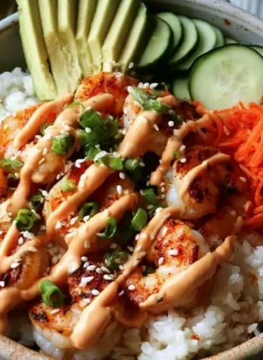 Delicious cozy shrimp rice bowls garnished with spicy mayo and fresh ingredients.