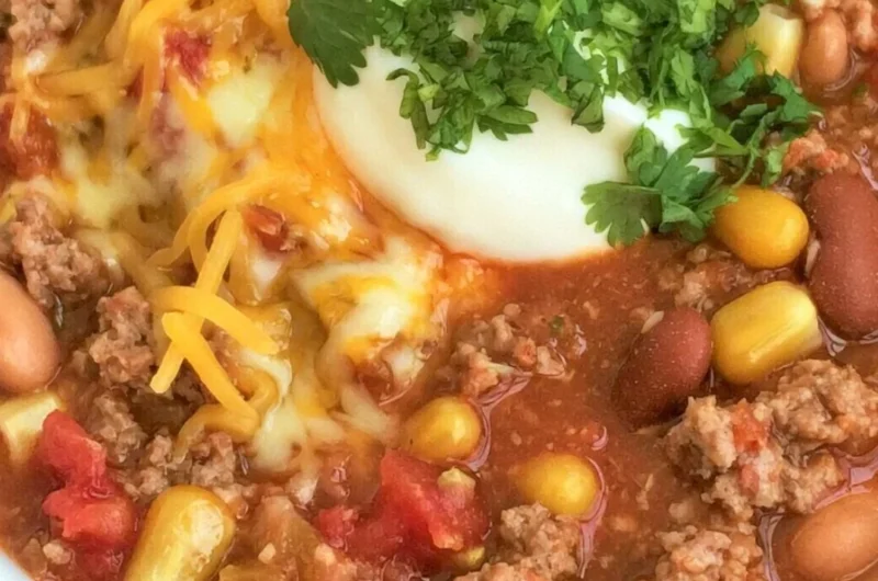Bowl of cozy taco soup garnished with fresh cilantro and avocado