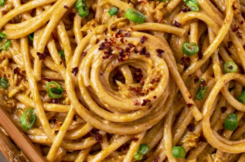 Cozy vegan garlic noodles garnished with fresh herbs and served in a bowl