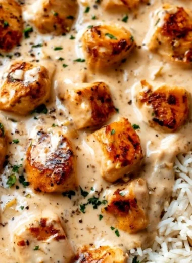 Creamy smothered chicken served over rice with a side of vegetables