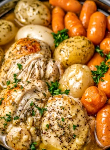 Delicious Crockpot Garlic Herb Chicken with mixed veggies in a cozy kitchen setting.