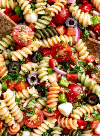 A vibrant bowl of Italian Pasta Salad with fresh vegetables and dressing