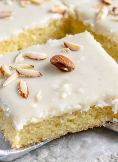 Delicious White Texas Almond Sheet Cake with almond frosting and toppings