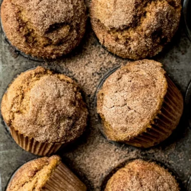 Freshly baked Pumpkin Snickerdoodle Muffins with cinnamon sugar topping