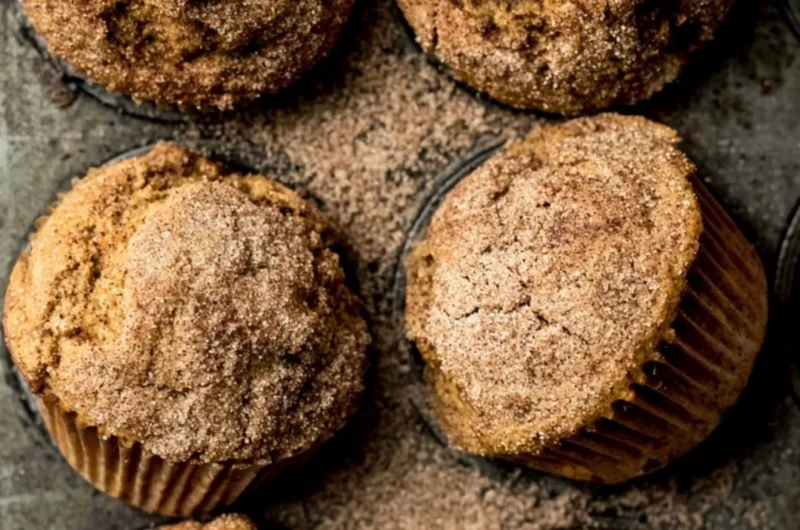 Freshly baked Pumpkin Snickerdoodle Muffins with cinnamon sugar topping