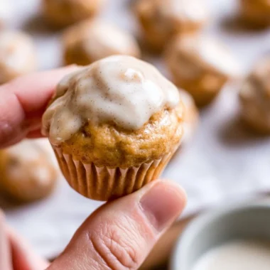 Mini chai muffins with vanilla bean glaze on a cooling rack